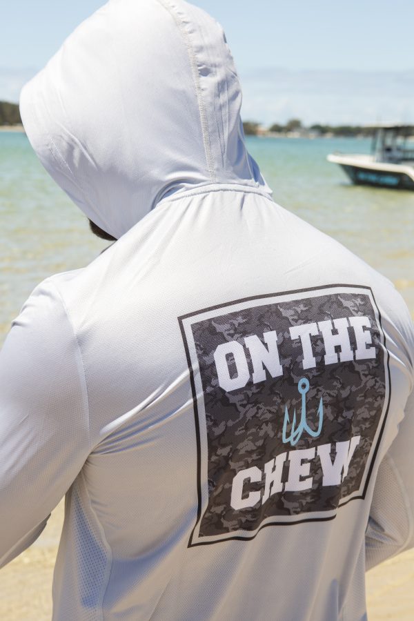 281A8220 scaled Fishing and lifestyle clothing. On The Chew <ul class="mybullet"> <li>Light weight hooded jersey with a built in franga</li> <li>Custom polyester blend for total comfort</li> <li>Soft & smooth 4-way stretch</li> <li>Ventilated for ultimate breathability</li> <li>Moisture wicking & fast drying</li> <li>UPF 30+ sun protection with collar</li> <li>Please note that due to variations amongst screens and photo lighting, actual colours may vary</li> </ul> <p style="text-align: center;">[button size="medium" style="secondary" text="Click to get in the box in a TEE" link="https://onthechew.com.au/product/in-the-box-tee/"]</p> $79.99